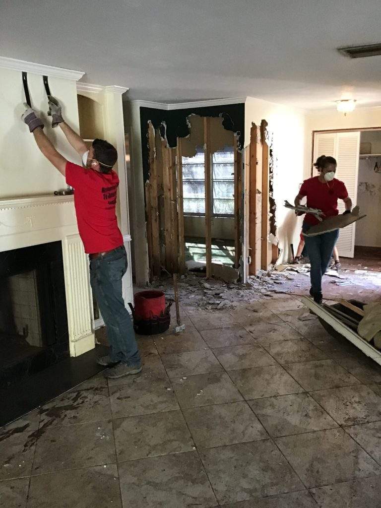 Chris In Action Group Removing Moldy Walls 
 in John's Living Room, Hurricane Ian