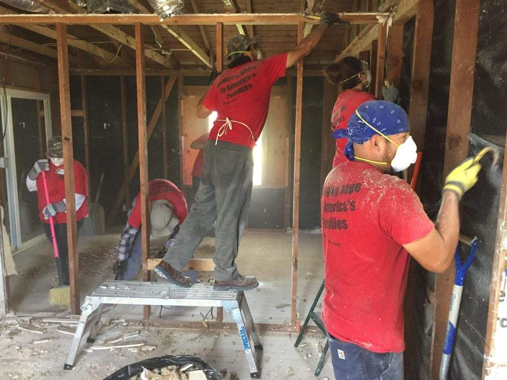 Christ In Action Free Disaster Relief Services Volunteers clearing walls of damaged house