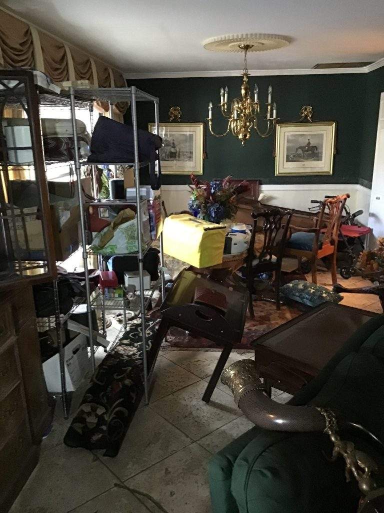 Water damaged furniture and belongings 
in John's Living room