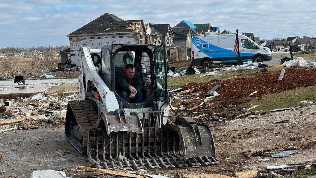 Christ In Action Free Disaster Relief team member with custom designed bobcat